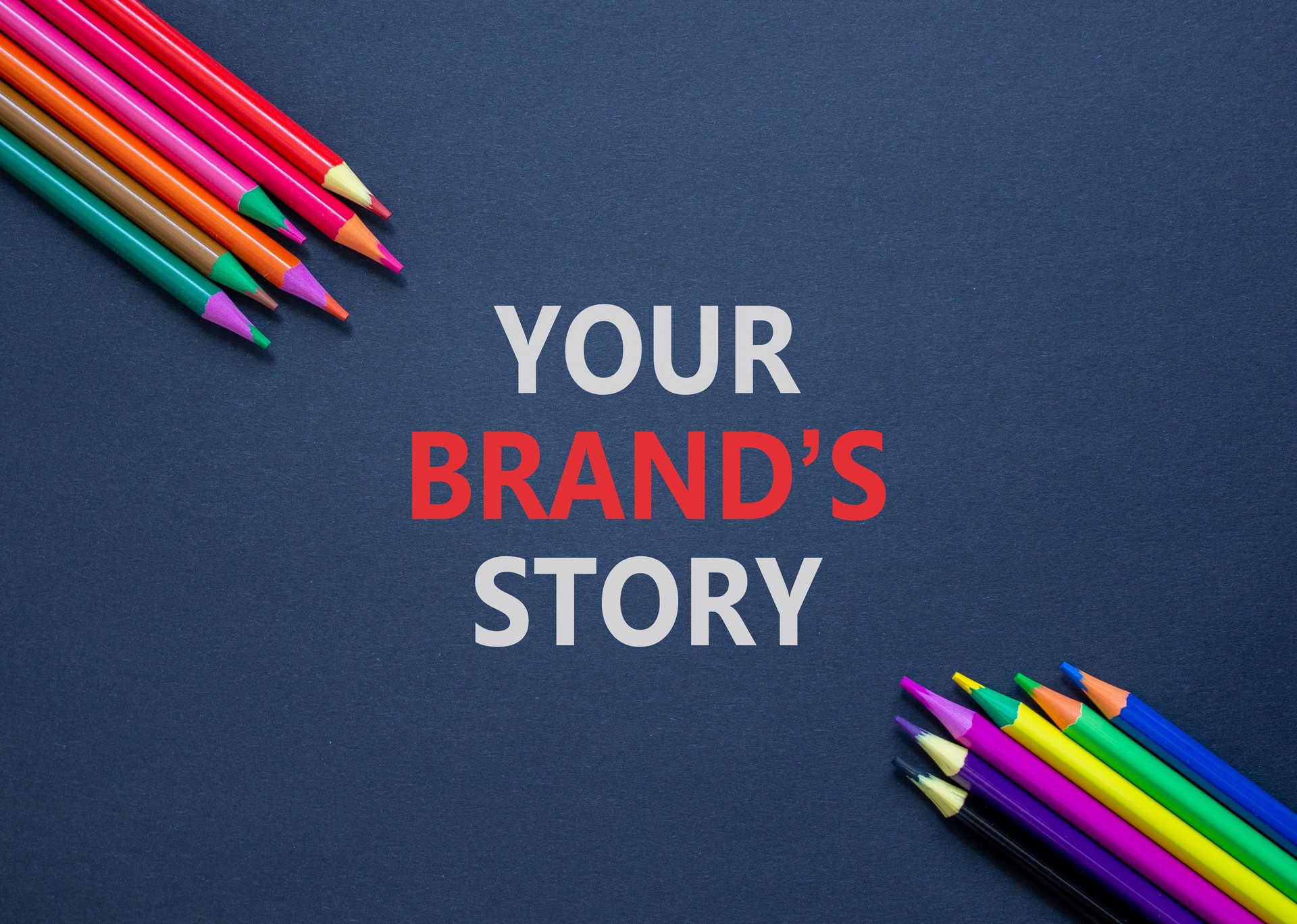 Branding and your brand story symbol. Concept words Your brands story on beautiful black paper. Beautiful black background. Colored pencils. Business branding your brand story concept. Copy space.